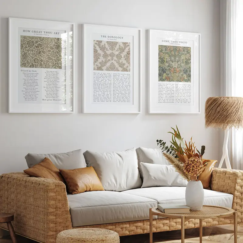 Three hymn art prints framed above a sofa in a sunlit living room